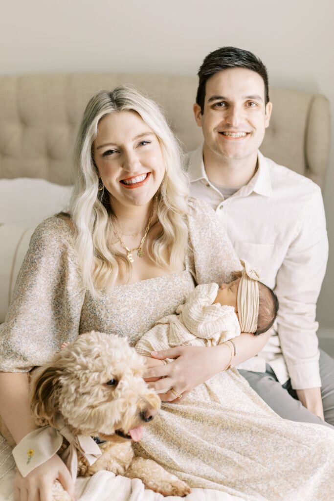 in home newborn photos baby with mom and dad and dog