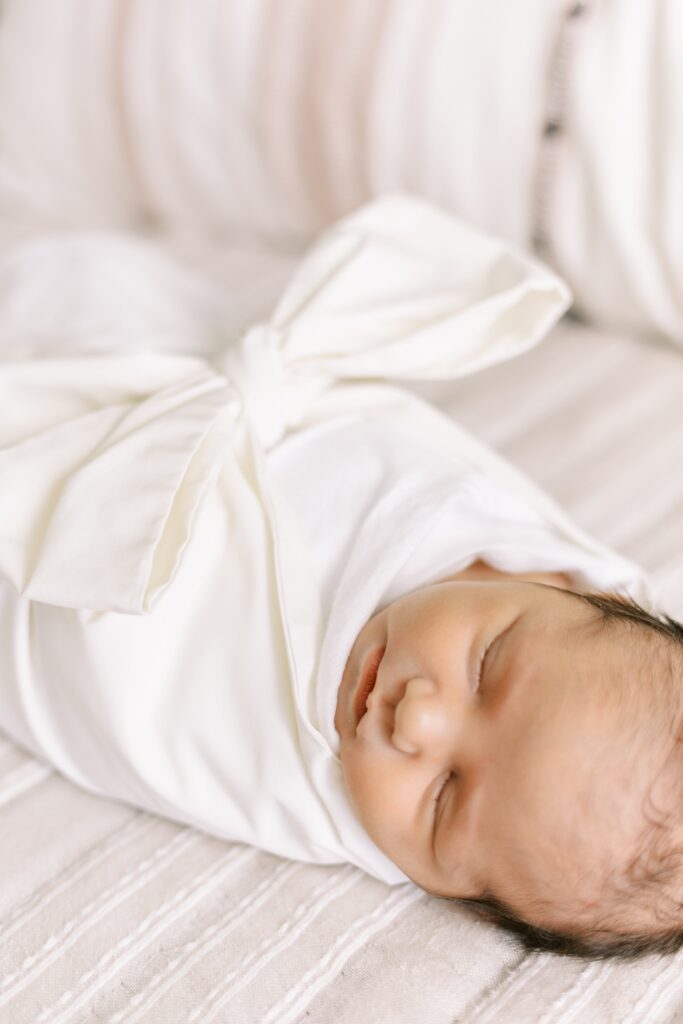 in home newborn photos baby on bed