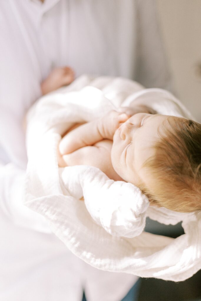 newborn baby being held by dad