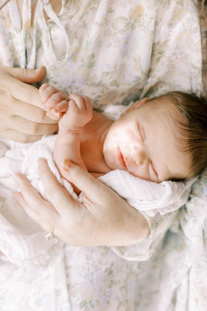 newborn baby held by mom