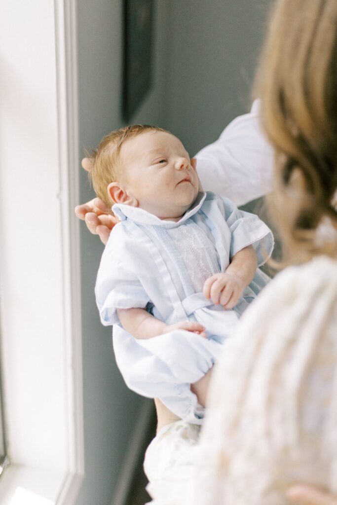 newborn baby being held by parents