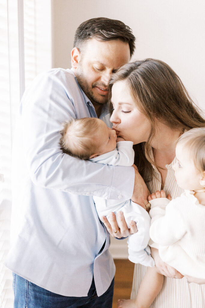 family hugging newborn baby