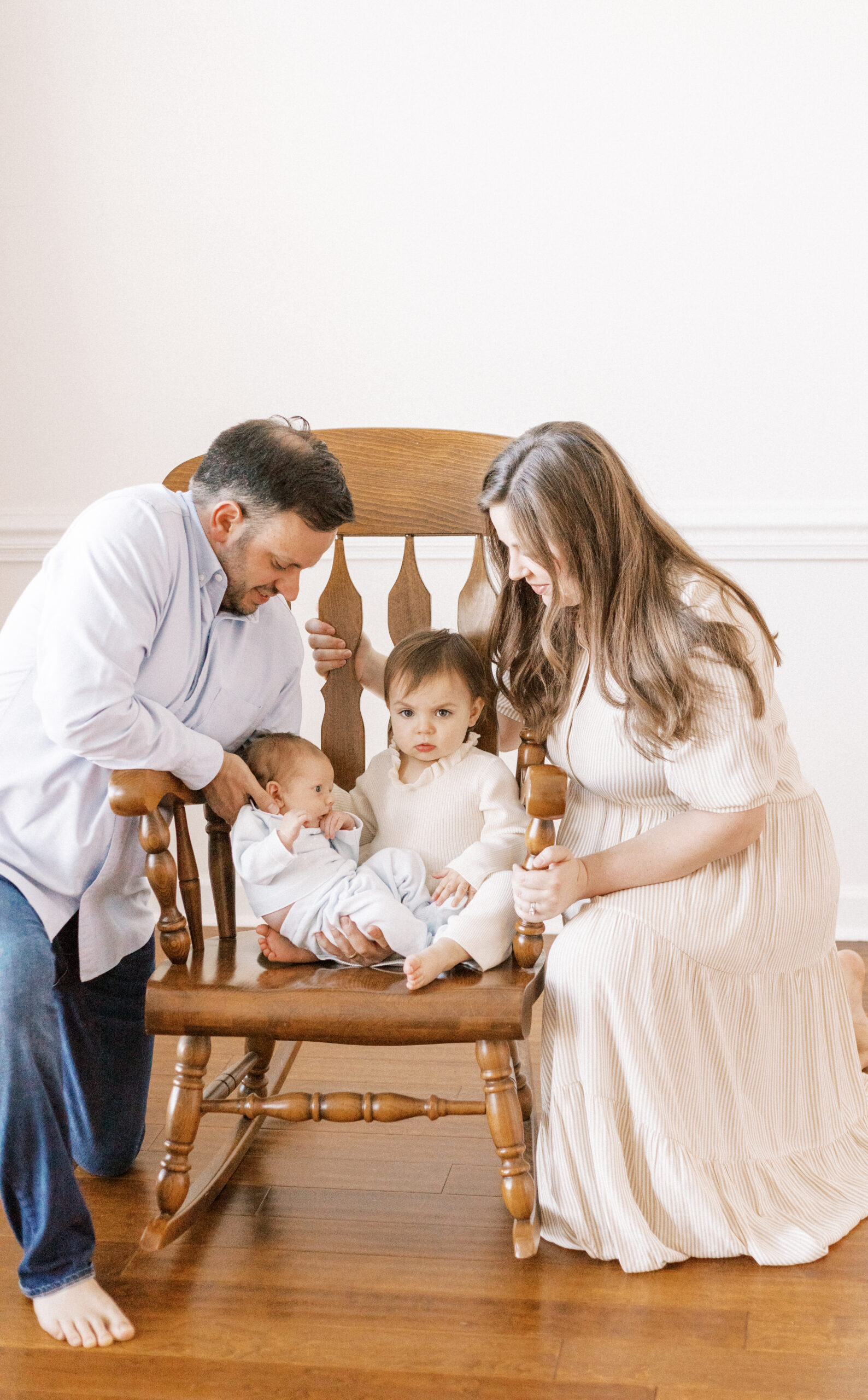 family with babies in classic rocking chair