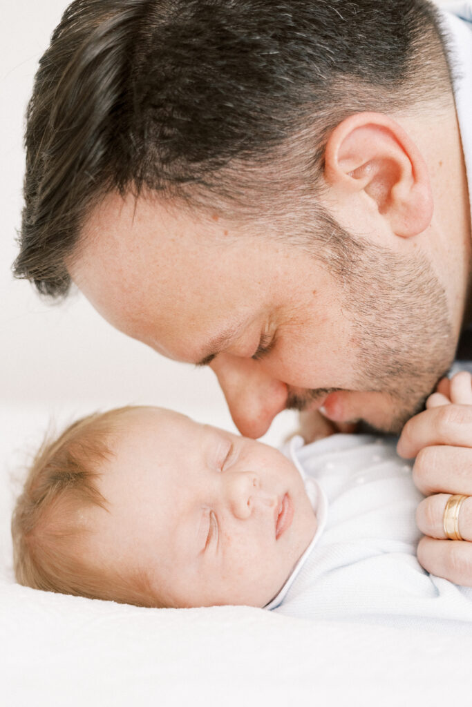 dad hugging newborn baby