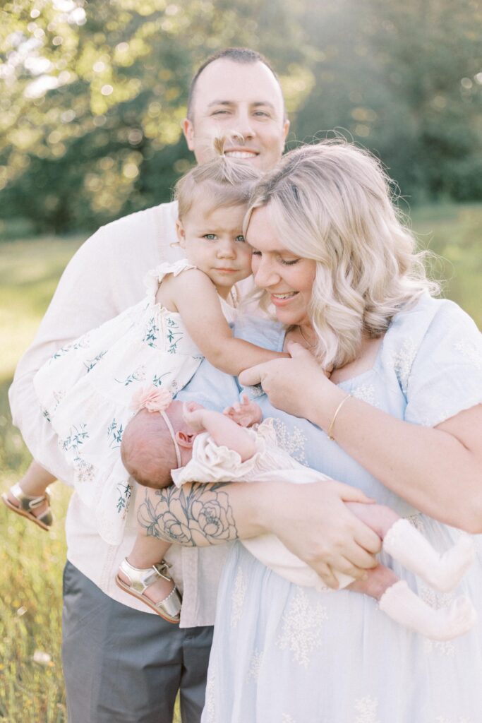 family hugging with baby in newborn photos in peoria illinois