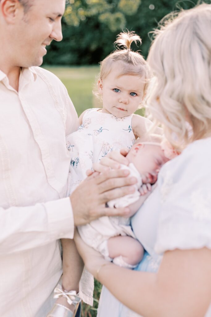 sister looking at the camera during peoria illinois baby photos