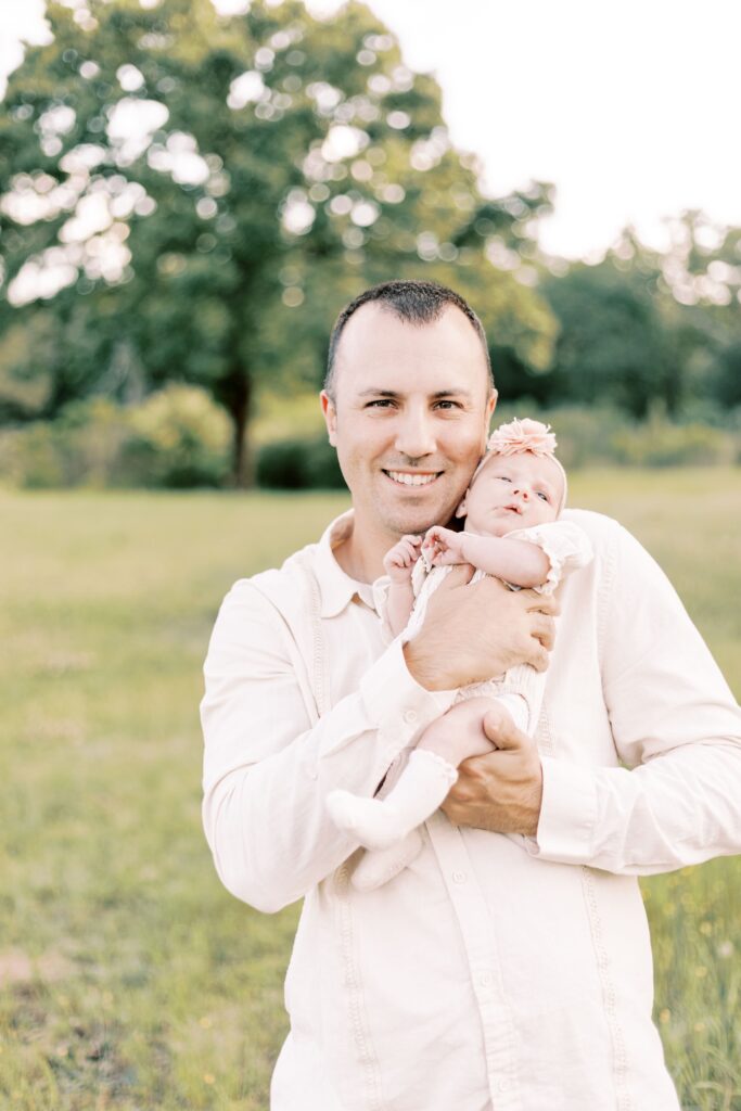 dad smiling with newborn baby in central illinois newborn photos