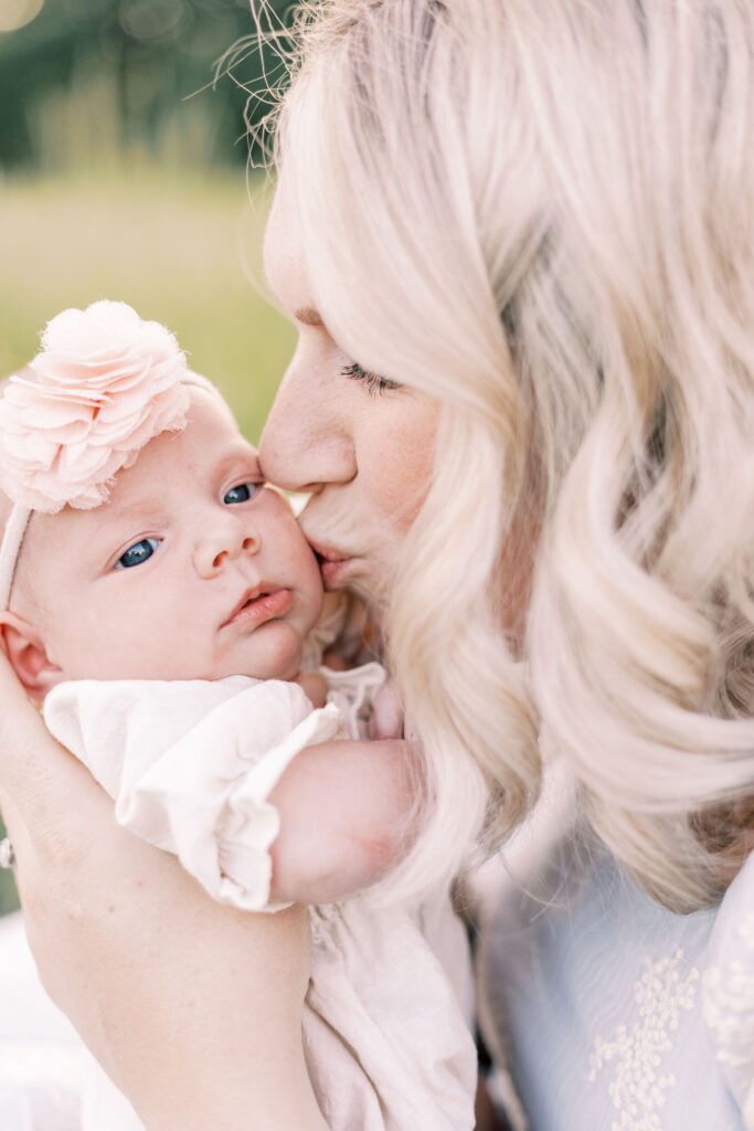 mom kissing baby's cheek in central illinois newborn photos