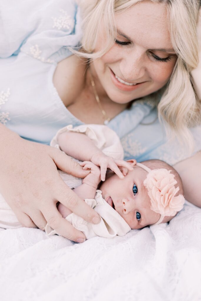 baby laying on blanket next to mom in central illinois newborn photos