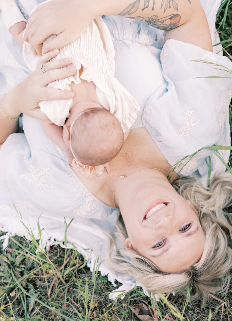 mom smiling as baby lays on chest in central illinois newborn photos