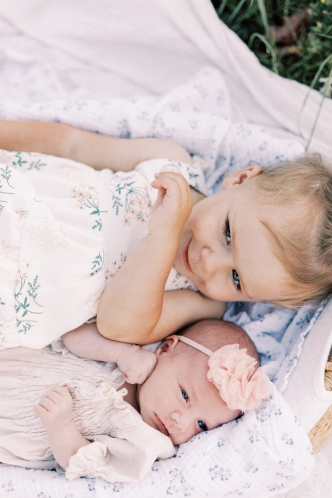 sisters in moses basket in central illinois newborn photos