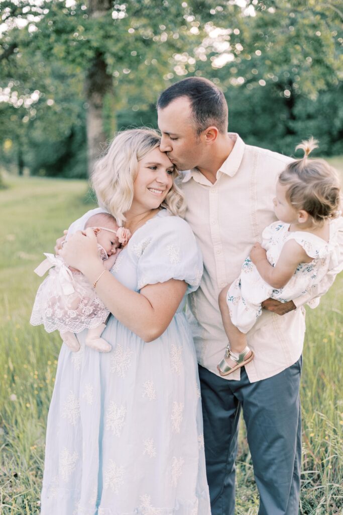 dad kissing mom during central illinois newborn photos