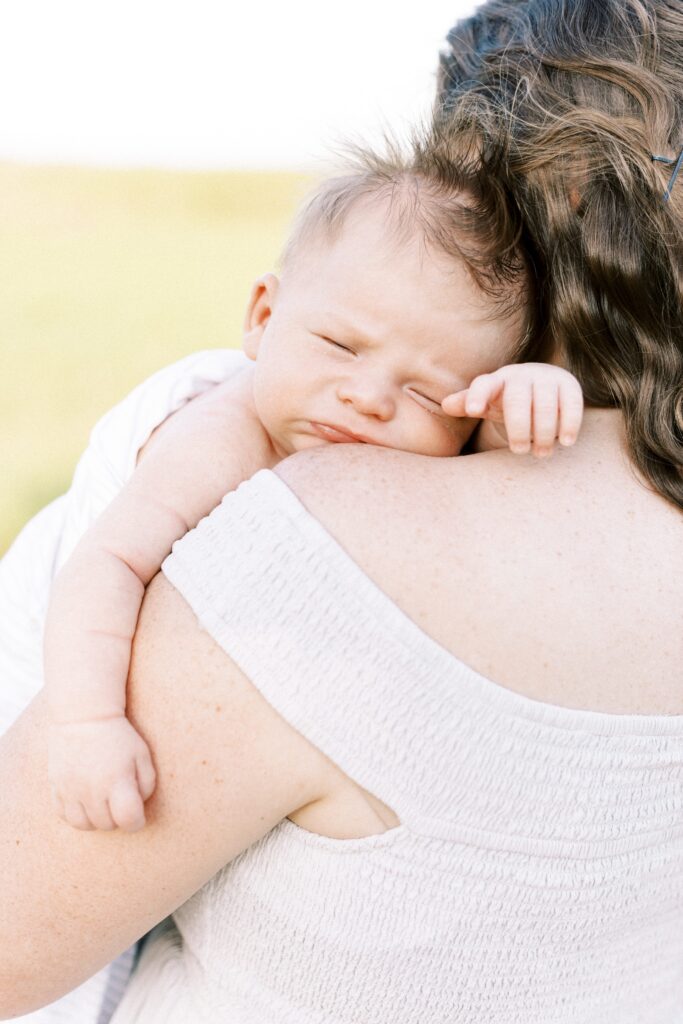 newborn baby resting on mom's shoulder in central il newborn photos