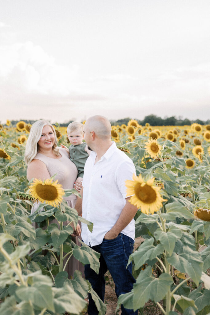 family walking through sunflower field in family photos