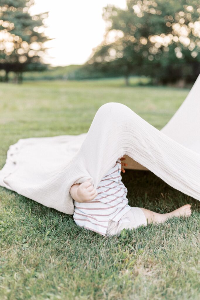 toddler playing hide and seek in peoria illinois family photos