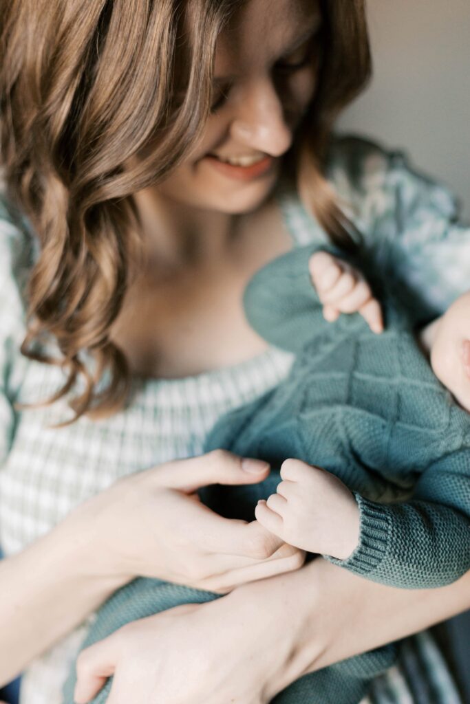 Detail photo of newborn hands and feet captured by a Peoria Illinois newborn photographer honoring the family’s privacy preferences