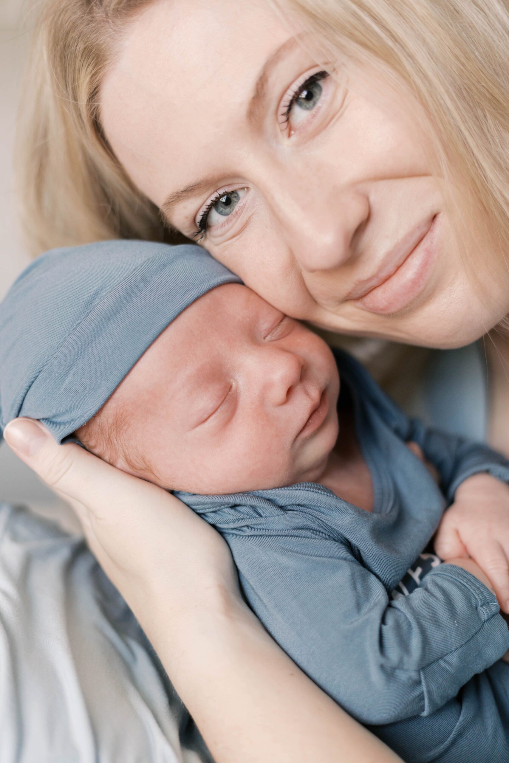 Peoria IL newborn photography session with parents holding their newborn baby at home during winter