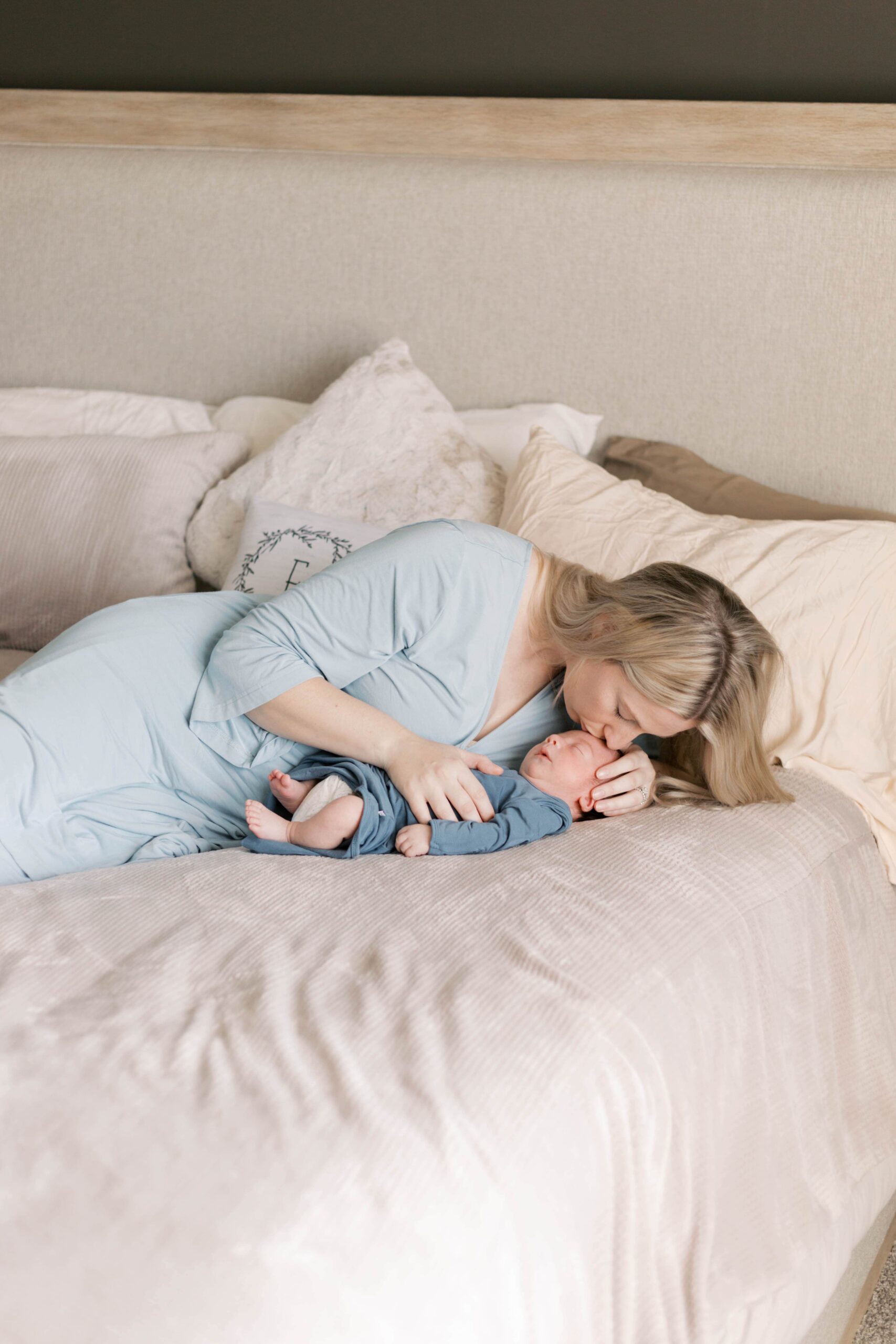 In-home newborn photos in Peoria, Illinois featuring a winter newborn session with parents at home