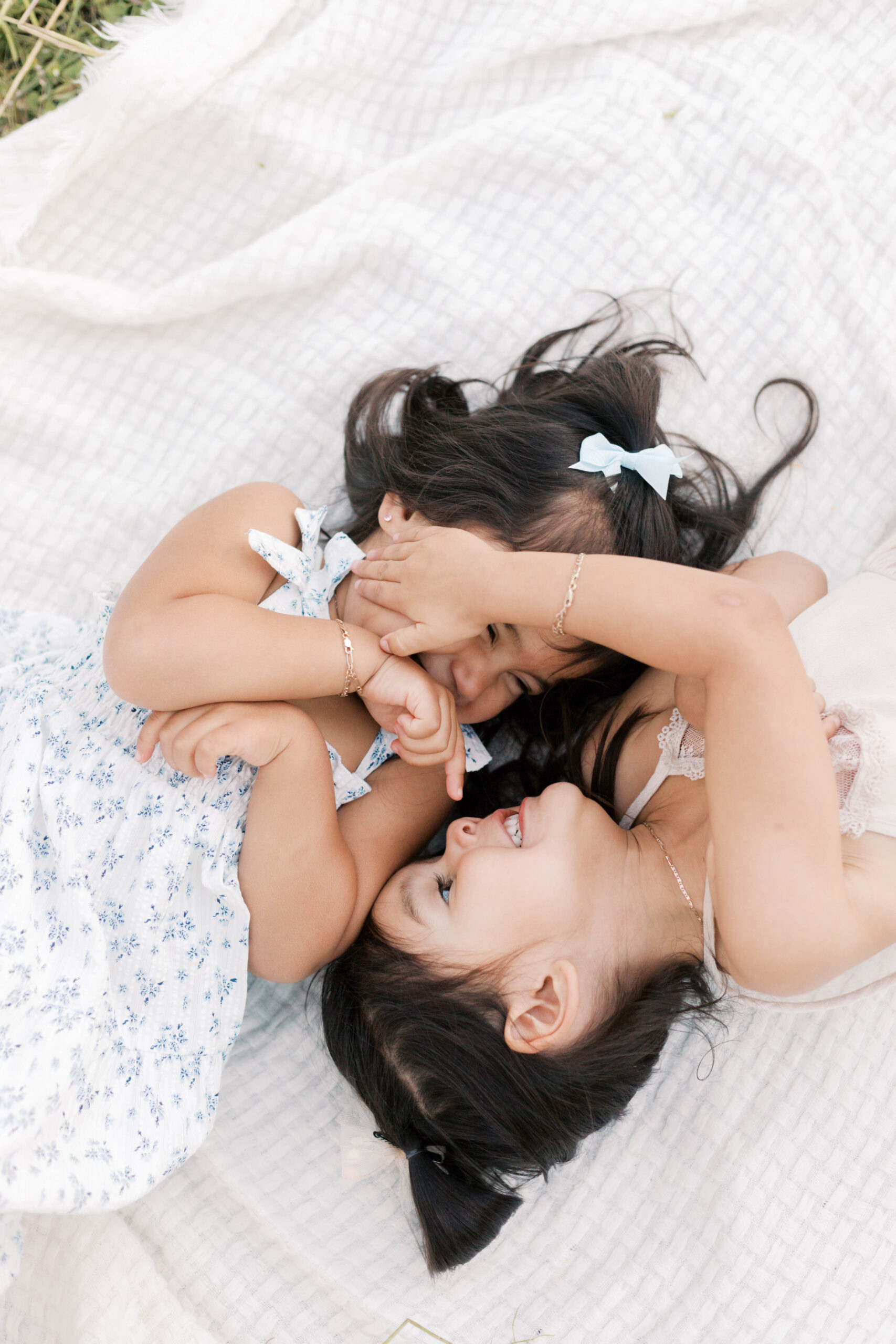 sisters playing during family photos in spring in peoria illinois