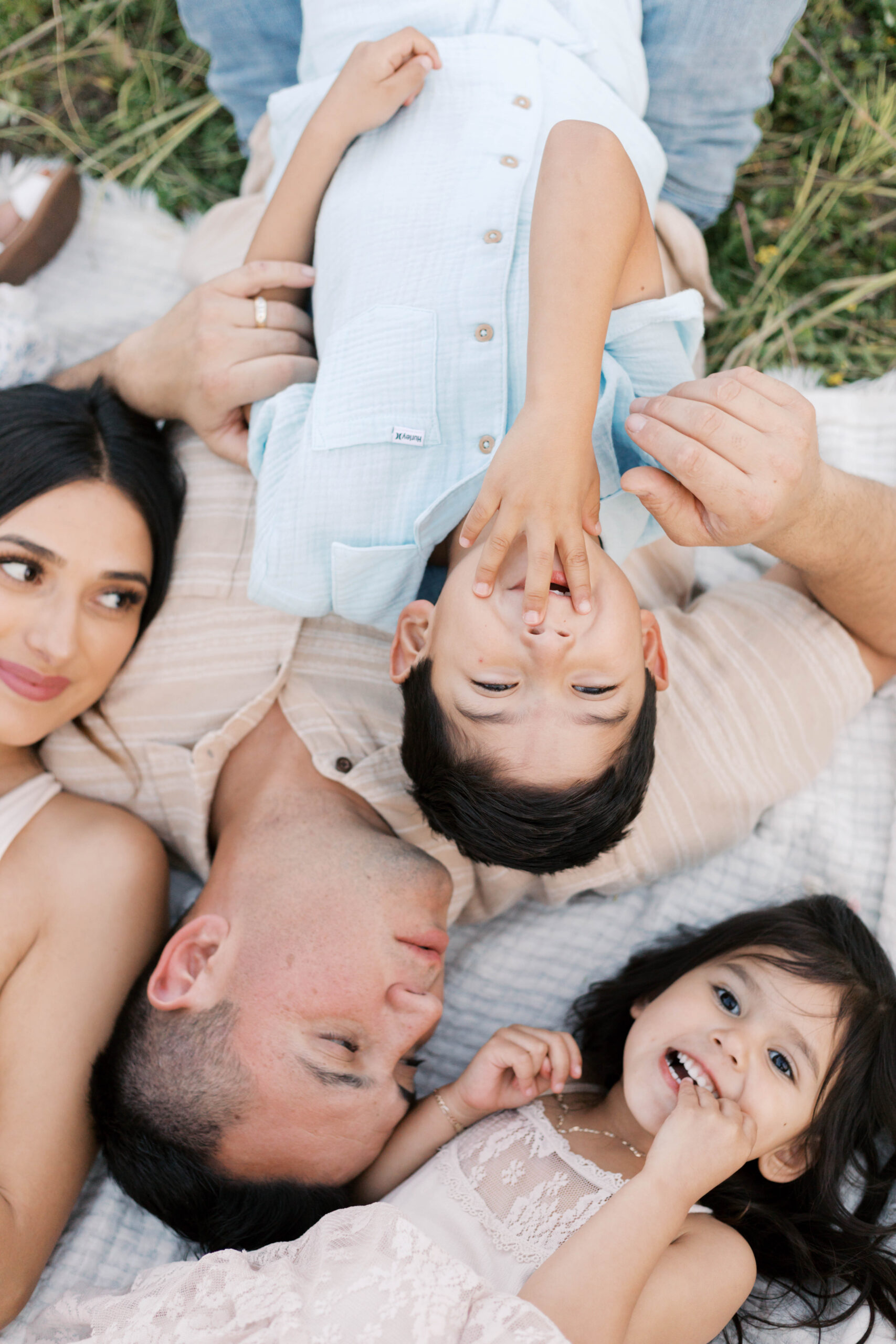 family playing in the grass in spring family photos in peoria illinois