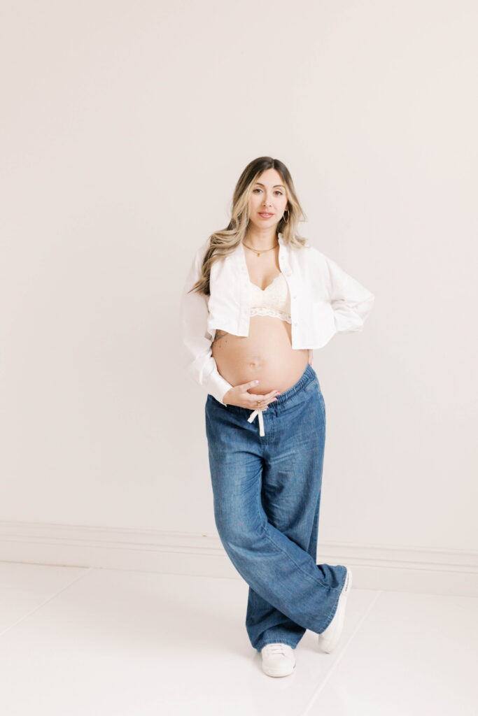 studio maternity photographer peoria il-33 pregnant woman in jeans and white tshirt in studio maternity session in peoria il