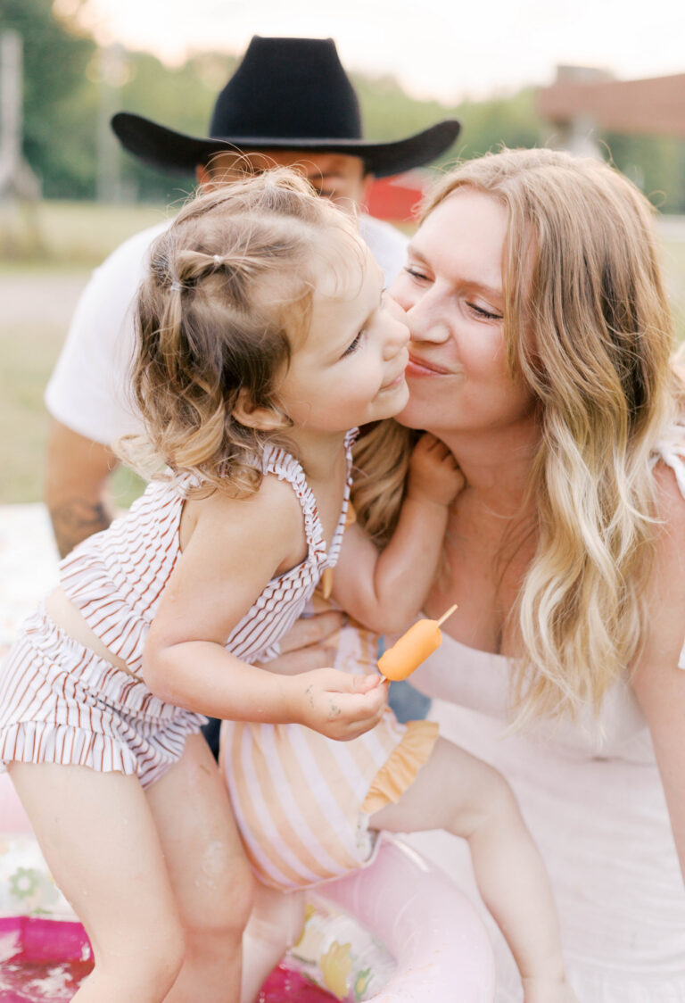 mom kissing daughter in summer backyard photos peoria il