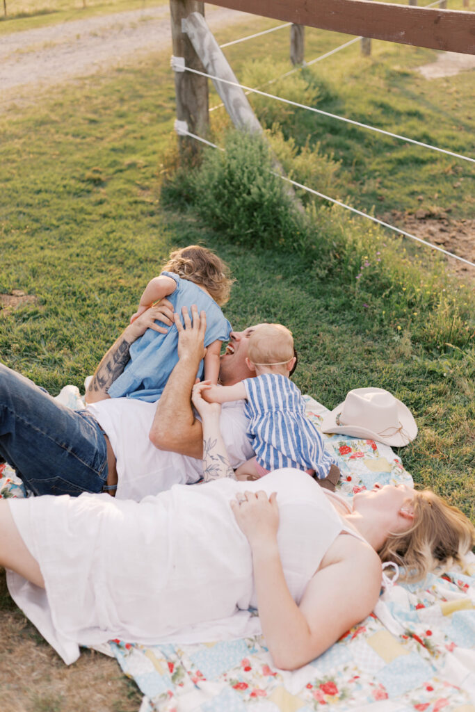 family laying on colorful blanket in peoria il family photos