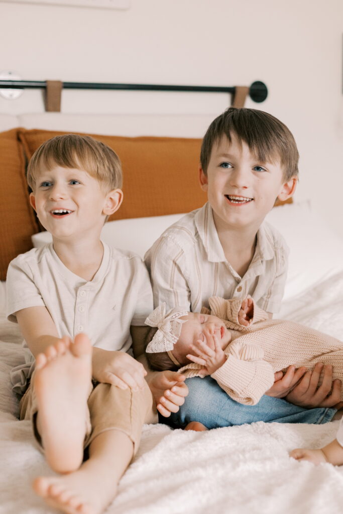 brothers with newborn sister in home newborn photography peoria il